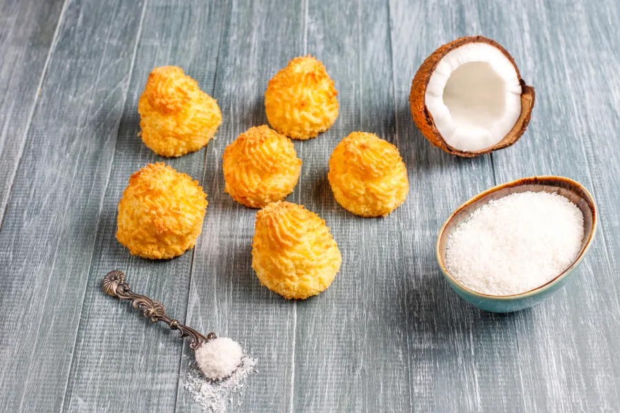 Golden coconut macaroons with fresh coconut and coconut flakes